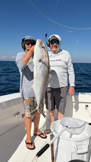Two anglers with an amberjack offshore